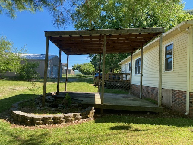 546 Rutledge Ford Road Decherd, TN 37324 - Photo 5 of 26 a view of a backyard with plants and a patio