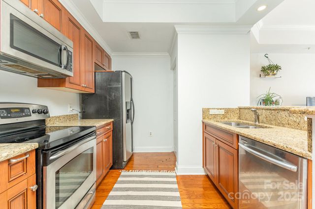 a kitchen with stainless steel appliances granite countertop a stove and a microwave