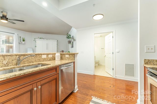 a bathroom with a granite countertop sink a mirror and a shower