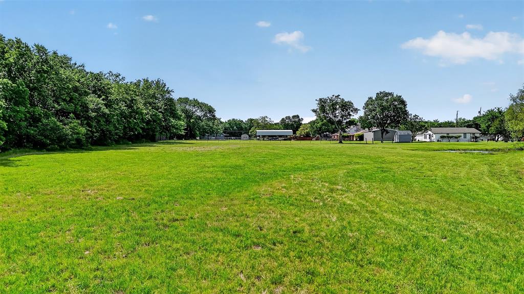 Tbd Pecan Street Ector, TX 75439 - Photo 13 of 18 a view of a green field with wooden fence