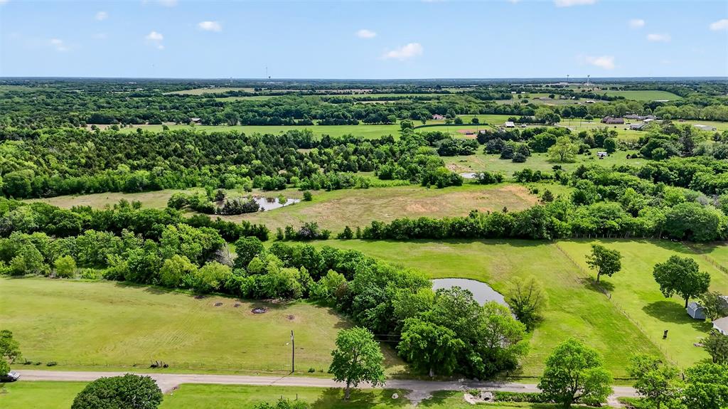 Tbd Pecan Street Ector, TX 75439 - Photo 3 of 18 a view of a green yard with a lake