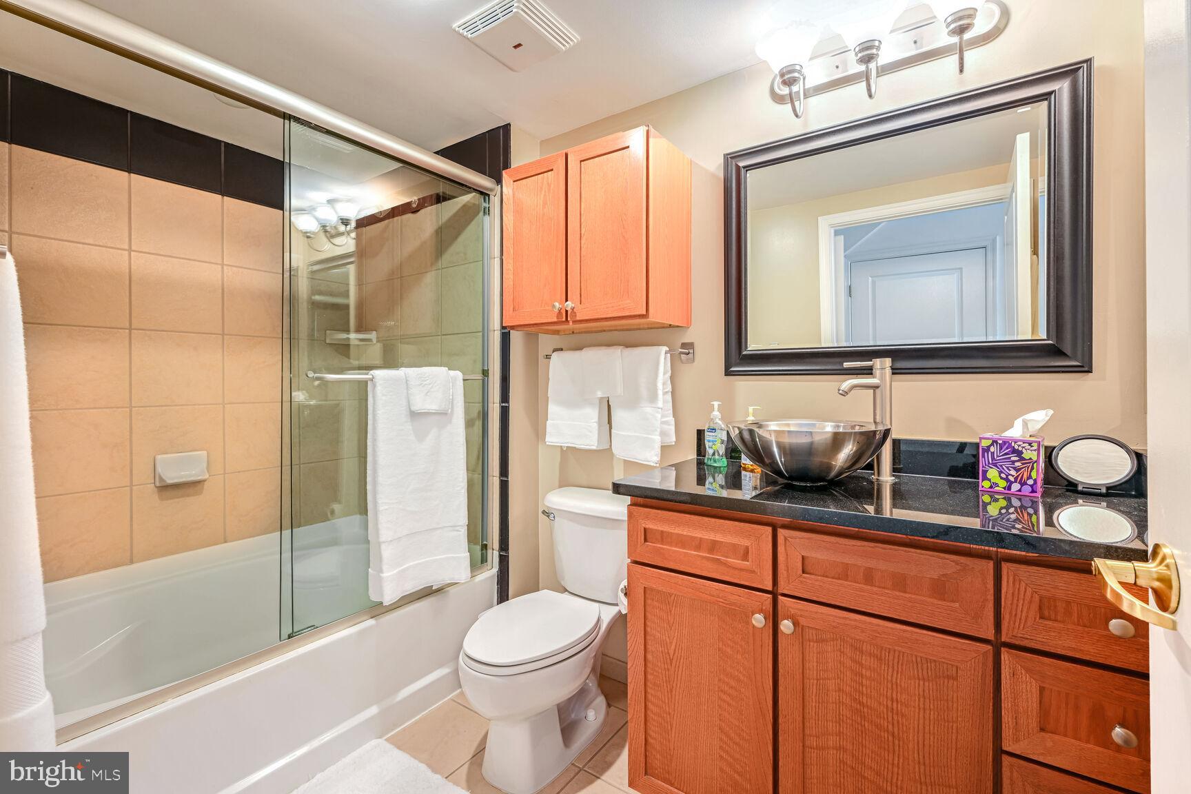 616 E Street Northwest, Unit 1150 Washington, DC 20004 - Photo 25 of 75 a bathroom with a sink a toilet and shower
