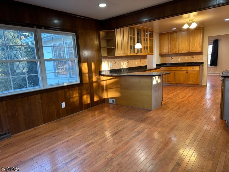 244 Olivia Street Ridgewood, NJ 07450 - Photo 12 of 43 a kitchen with stainless steel appliances granite countertop a stove a sink and a large window