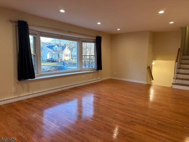 244 Olivia Street Ridgewood, NJ 07450 - Photo 13 of 43 an empty room with wooden floor and windows