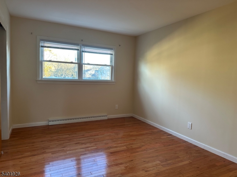 244 Olivia Street Ridgewood, NJ 07450 - Photo 14 of 43 a view of an empty room with wooden floor and a window