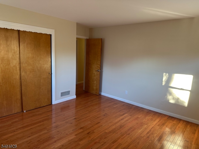 244 Olivia Street Ridgewood, NJ 07450 - Photo 17 of 43 a view of an empty room with wooden floor and a window