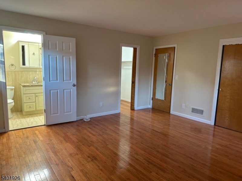 244 Olivia Street Ridgewood, NJ 07450 - Photo 19 of 43 an empty room with wooden floor and windows