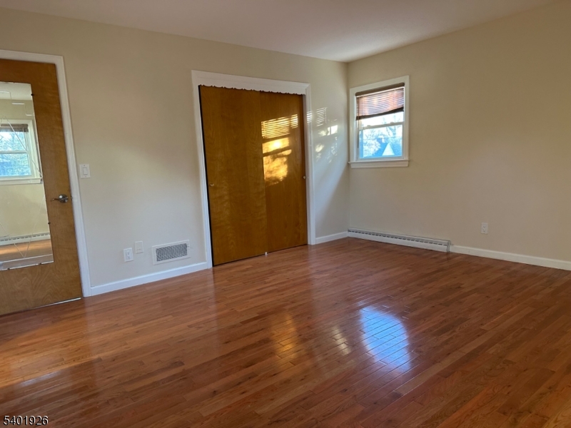 244 Olivia Street Ridgewood, NJ 07450 - Photo 20 of 43 a view of an empty room with wooden floor and a window
