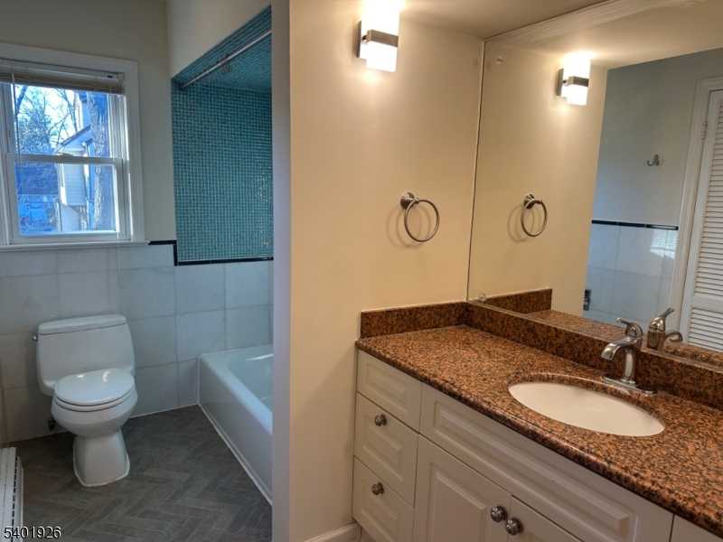 244 Olivia Street Ridgewood, NJ 07450 - Photo 25 of 43 a bathroom with a granite countertop sink toilet and shower