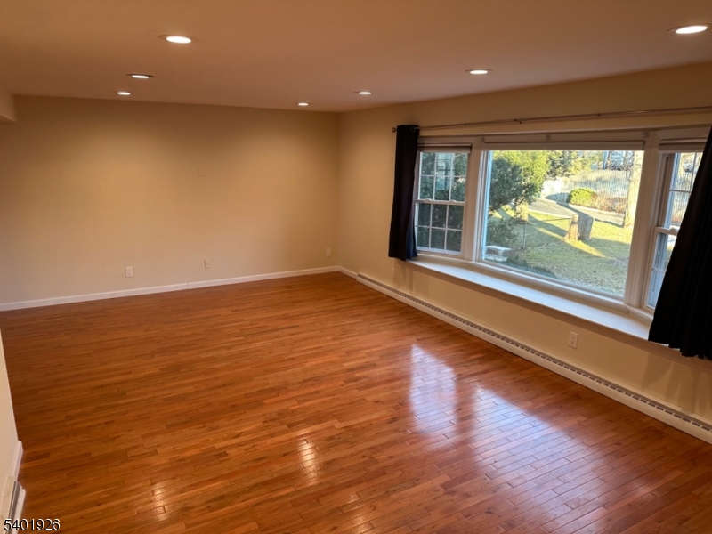 244 Olivia Street Ridgewood, NJ 07450 - Photo 28 of 43 a view of an empty room with wooden floor and a window