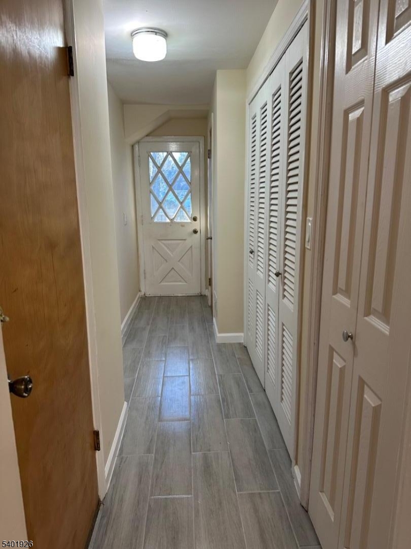 244 Olivia Street Ridgewood, NJ 07450 - Photo 29 of 43 a view of a hallway with wooden floor