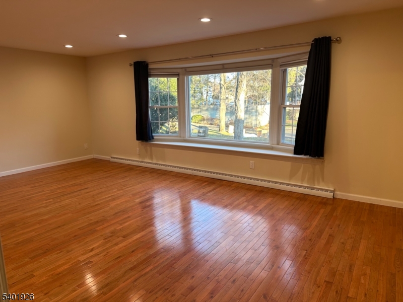 244 Olivia Street Ridgewood, NJ 07450 - Photo 3 of 43 a view of an empty room with wooden floor and a window