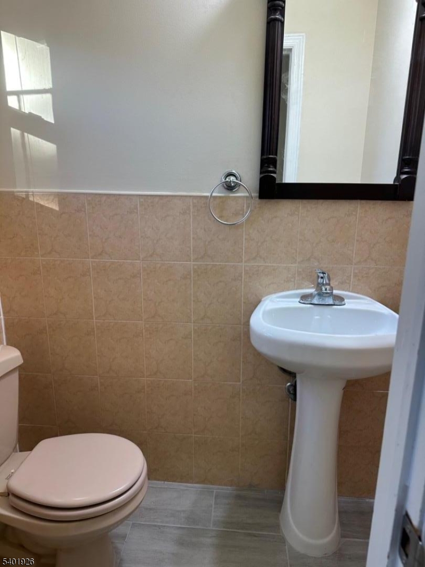 244 Olivia Street Ridgewood, NJ 07450 - Photo 33 of 43 a bathroom with a toilet sink and mirror