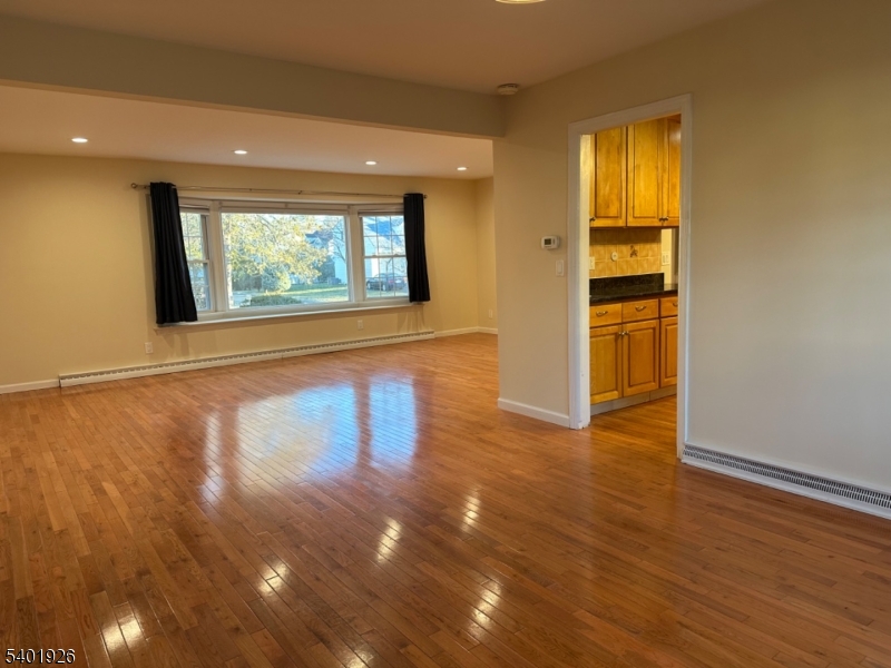 244 Olivia Street Ridgewood, NJ 07450 - Photo 5 of 43 a view of an empty room with wooden floor and a window