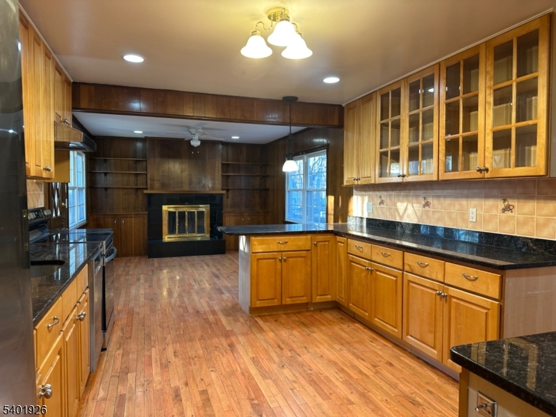 244 Olivia Street Ridgewood, NJ 07450 - Photo 9 of 43 a large kitchen with stainless steel appliances wooden floor and a view of living room