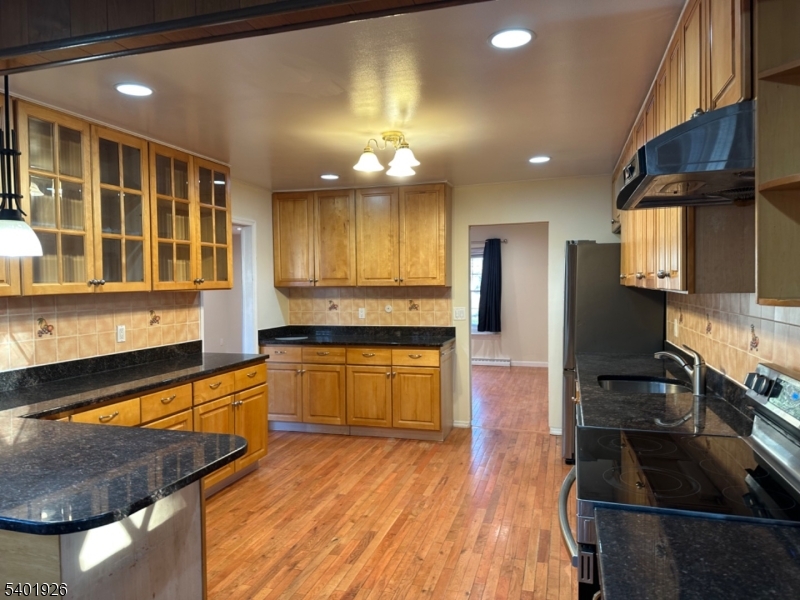 244 Olivia Street Ridgewood, NJ 07450 - Photo 10 of 43 a kitchen with stainless steel appliances granite countertop a stove and a wooden floors
