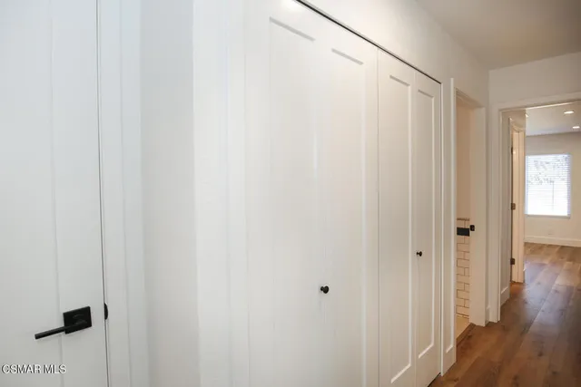 a view of a hallway with wooden floor