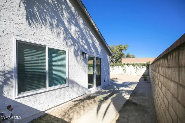 a view of house with backyard and outdoor seating