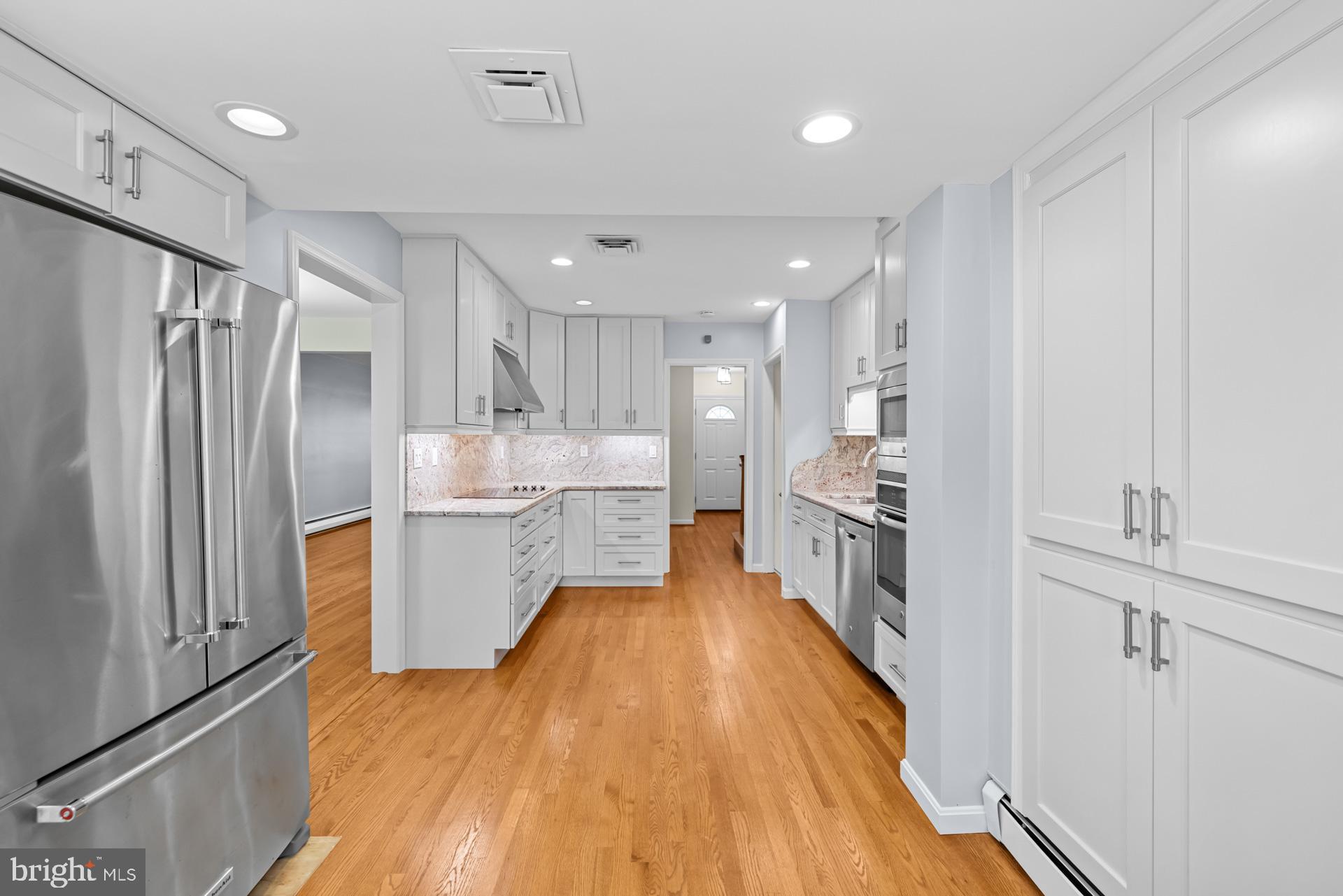 807 Winhall Way Silver Spring, MD 20904 - Photo 28 of 82 a large kitchen with a center island wooden floor and stainless steel appliances
