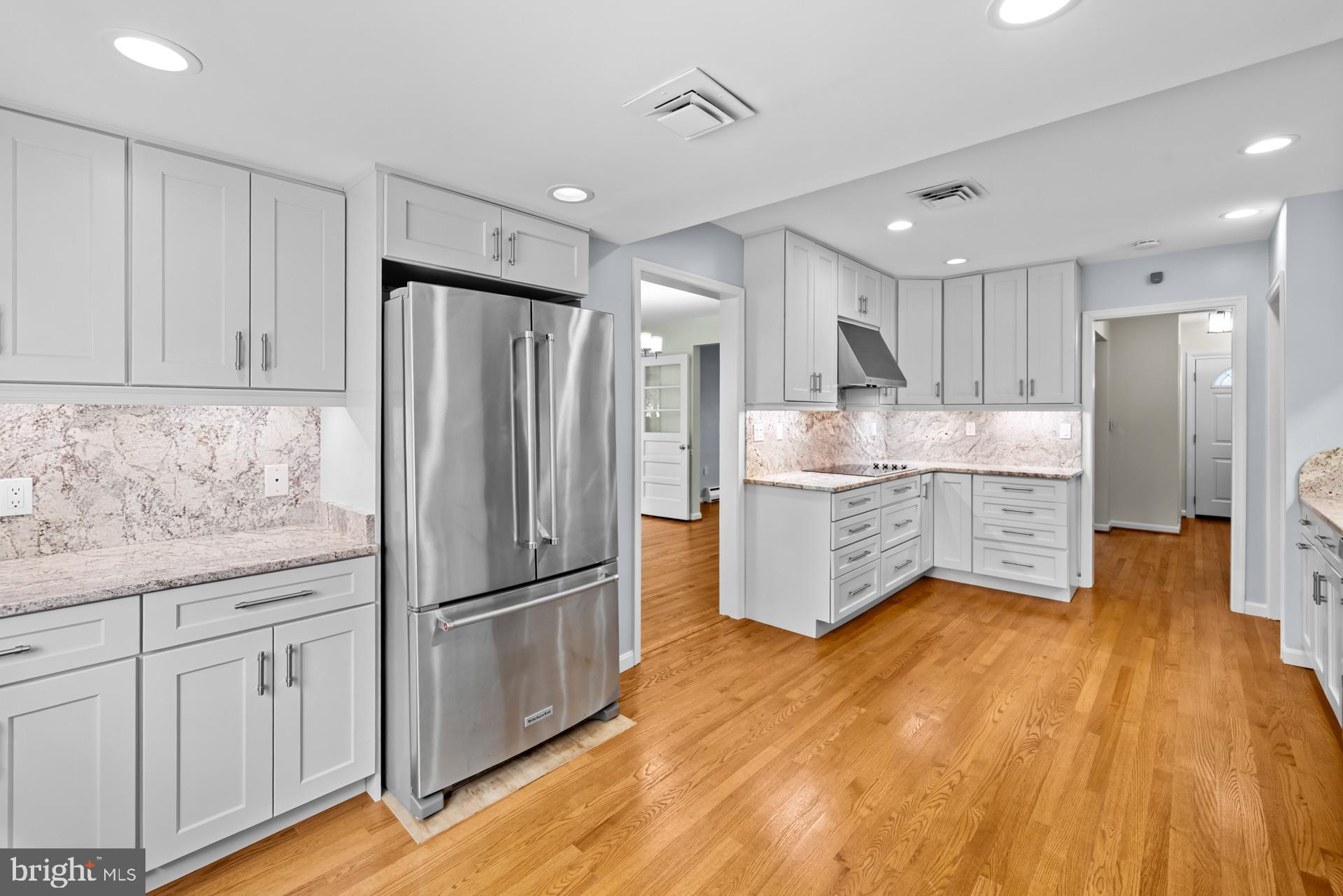 807 Winhall Way Silver Spring, MD 20904 - Photo 29 of 82 a kitchen with stainless steel appliances granite countertop a refrigerator and a stove top oven