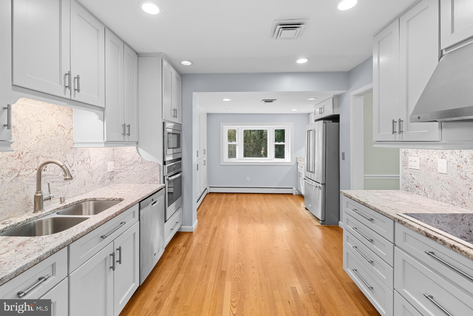 807 Winhall Way Silver Spring, MD 20904 - Photo 30 of 82 a large kitchen with a lot of counter space and wooden floor