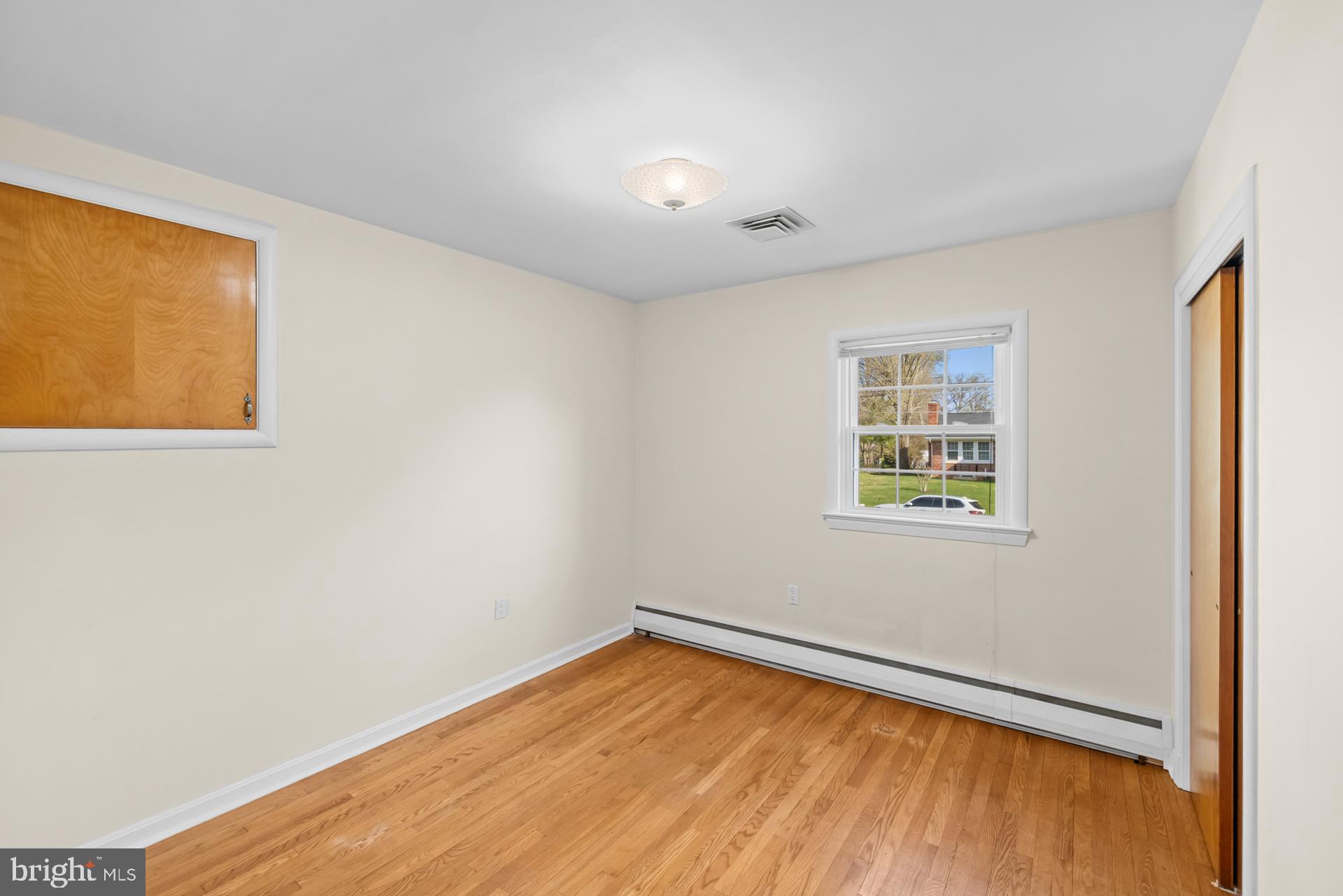 807 Winhall Way Silver Spring, MD 20904 - Photo 37 of 82 a view of an empty room with wooden floor and a window