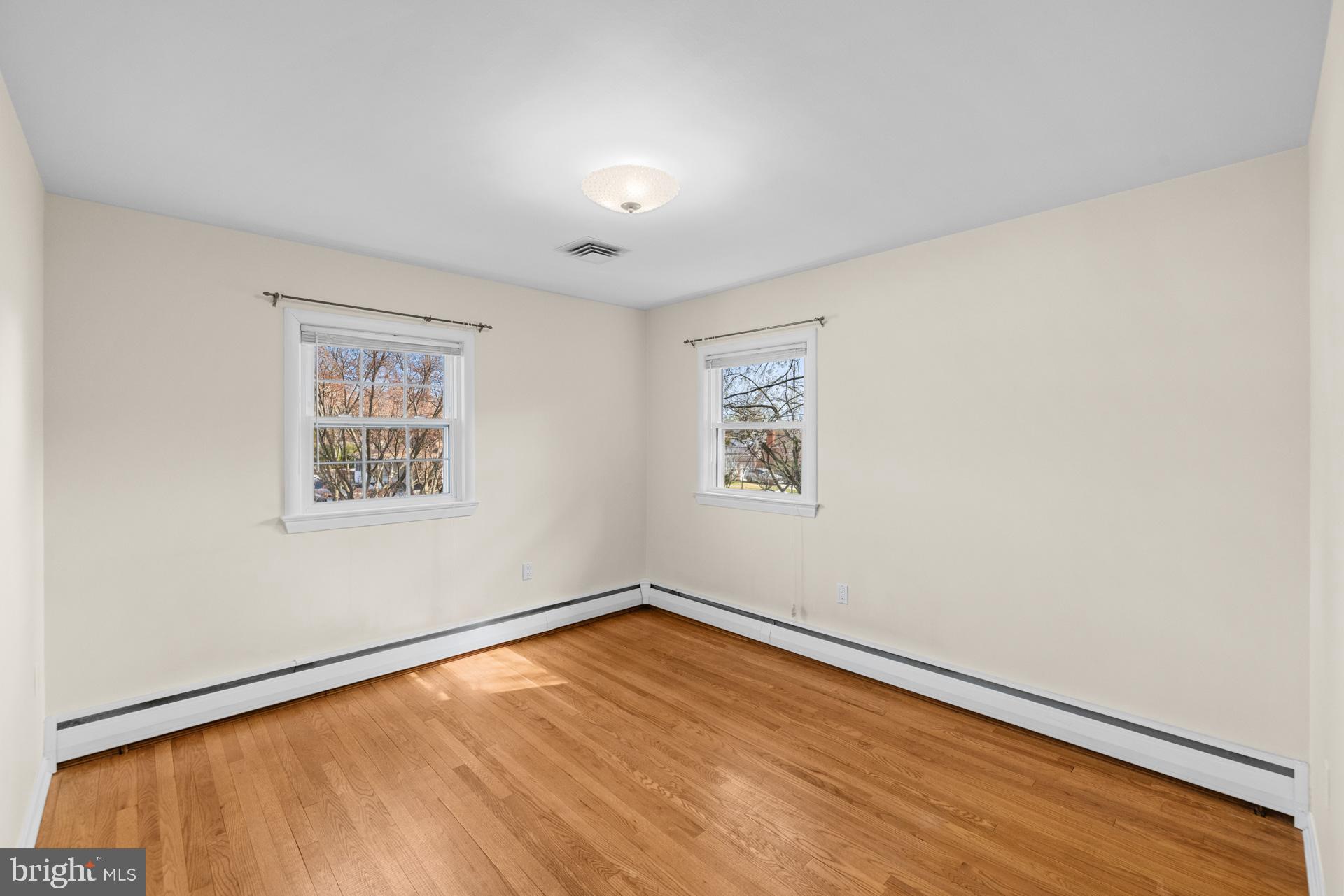 807 Winhall Way Silver Spring, MD 20904 - Photo 39 of 82 an empty room with a wooden floor and windows
