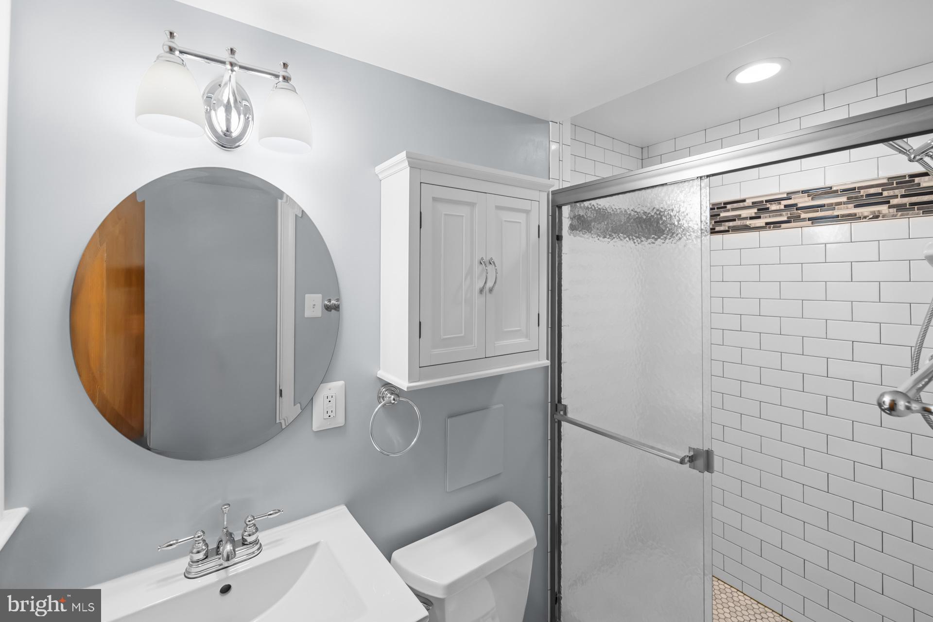 807 Winhall Way Silver Spring, MD 20904 - Photo 52 of 82 a bathroom with a sink mirror and vanity