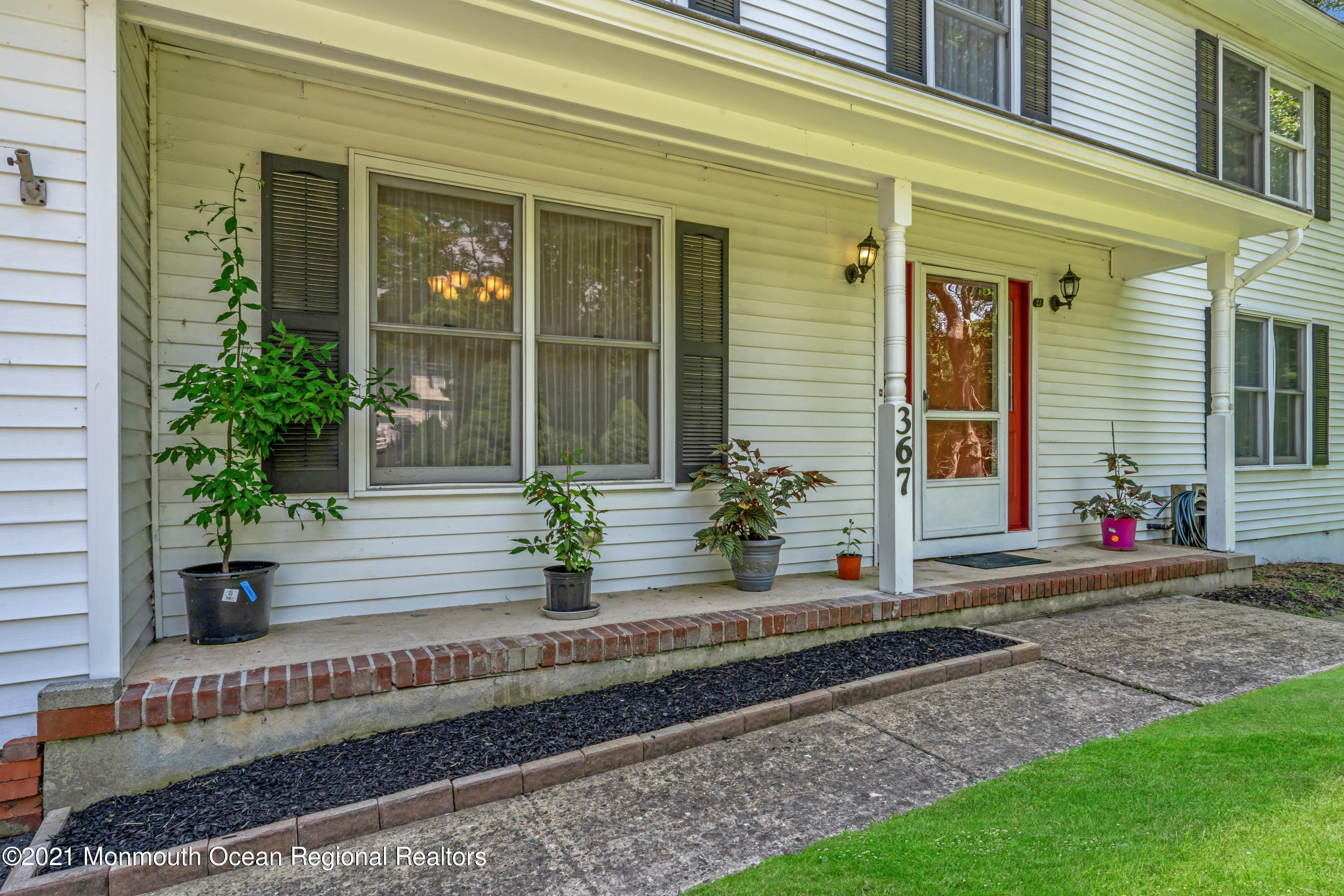 367 East Pleasant Grove Road Jackson, NJ 08527 - Photo 5 of 45 a view of a house with potted plants and a bench