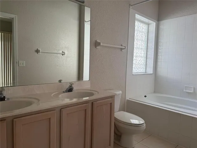 a view of a kitchen with fridge and a stove top oven