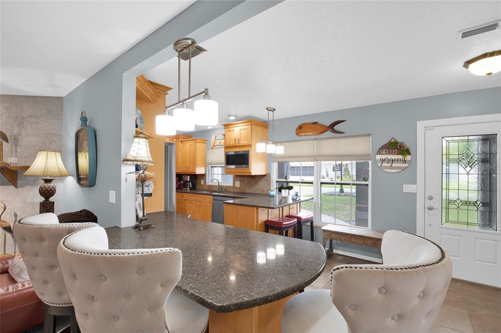 4121 South Roosevelt Point Homosassa, FL 34448 - Photo 12 of 47 a living room with dining table and a large window
