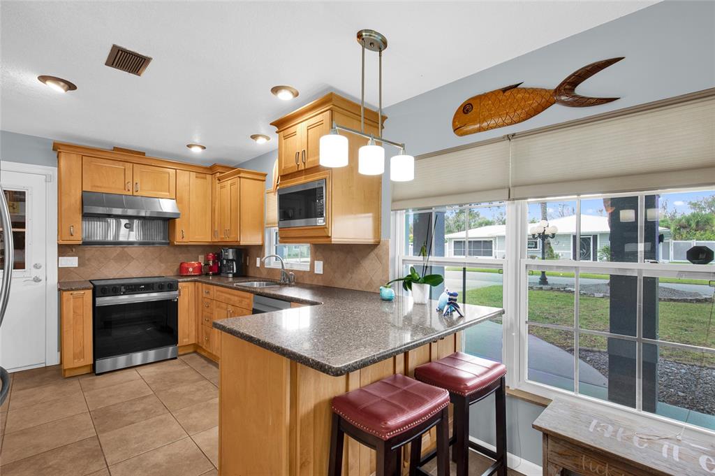 4121 South Roosevelt Point Homosassa, FL 34448 - Photo 13 of 47 a kitchen with a table chairs stove and cabinets
