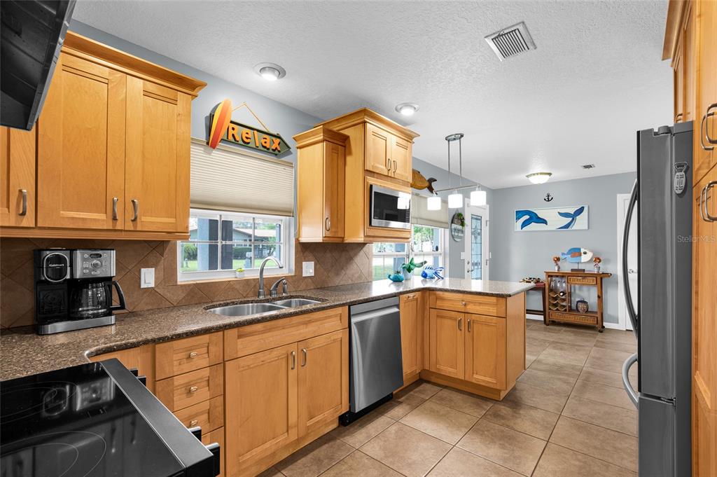 4121 South Roosevelt Point Homosassa, FL 34448 - Photo 15 of 47 a kitchen with a sink refrigerator and cabinets
