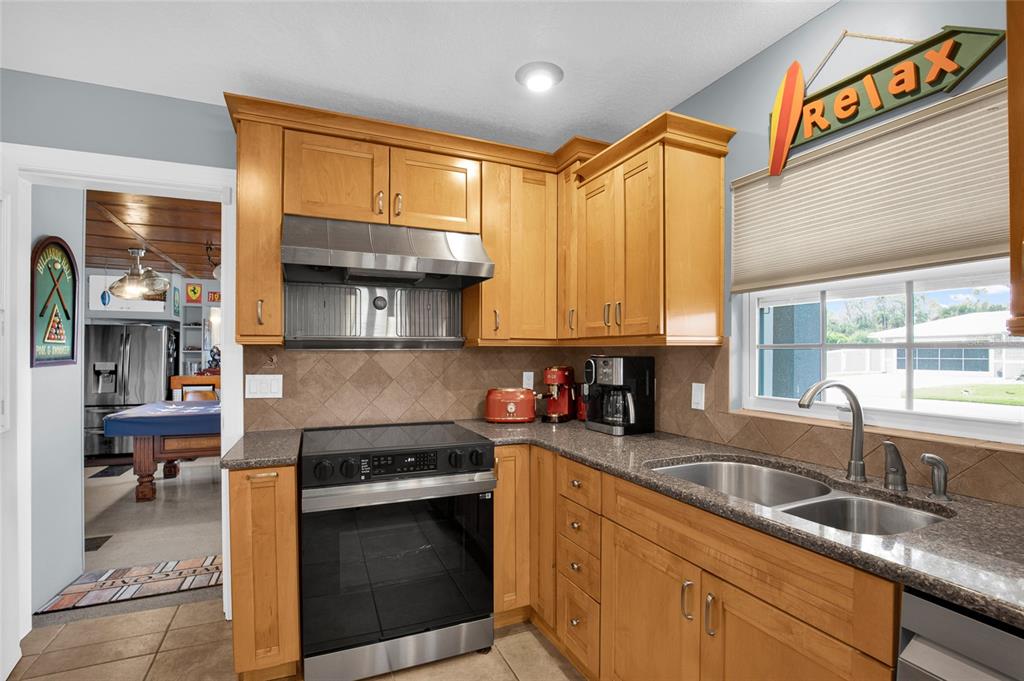 4121 South Roosevelt Point Homosassa, FL 34448 - Photo 17 of 47 a kitchen with stainless steel appliances granite countertop a sink a stove and a refrigerator