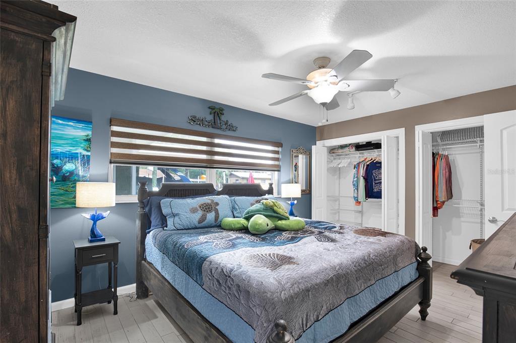 4121 South Roosevelt Point Homosassa, FL 34448 - Photo 19 of 47 a bedroom with a bed and a chandelier