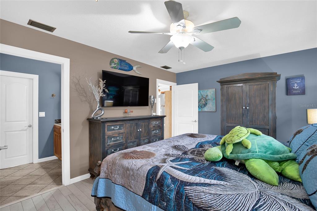 4121 South Roosevelt Point Homosassa, FL 34448 - Photo 20 of 47 a bedroom with a bed and a flat screen tv