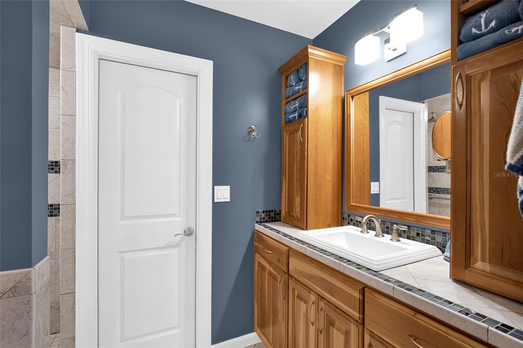 4121 South Roosevelt Point Homosassa, FL 34448 - Photo 21 of 47 a bathroom with a granite countertop sink and a mirror