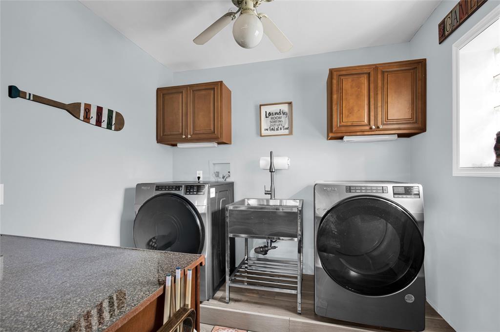 4121 South Roosevelt Point Homosassa, FL 34448 - Photo 26 of 47 a bedroom with a bed and a chandelier