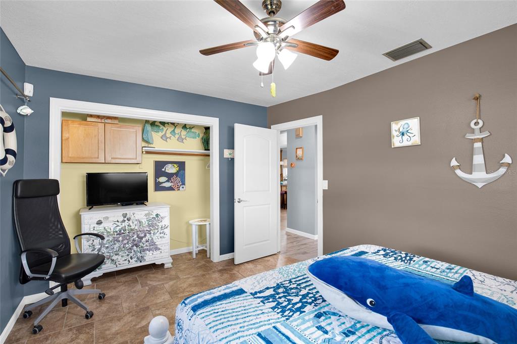 4121 South Roosevelt Point Homosassa, FL 34448 - Photo 29 of 47 a bedroom with a bed and a couch