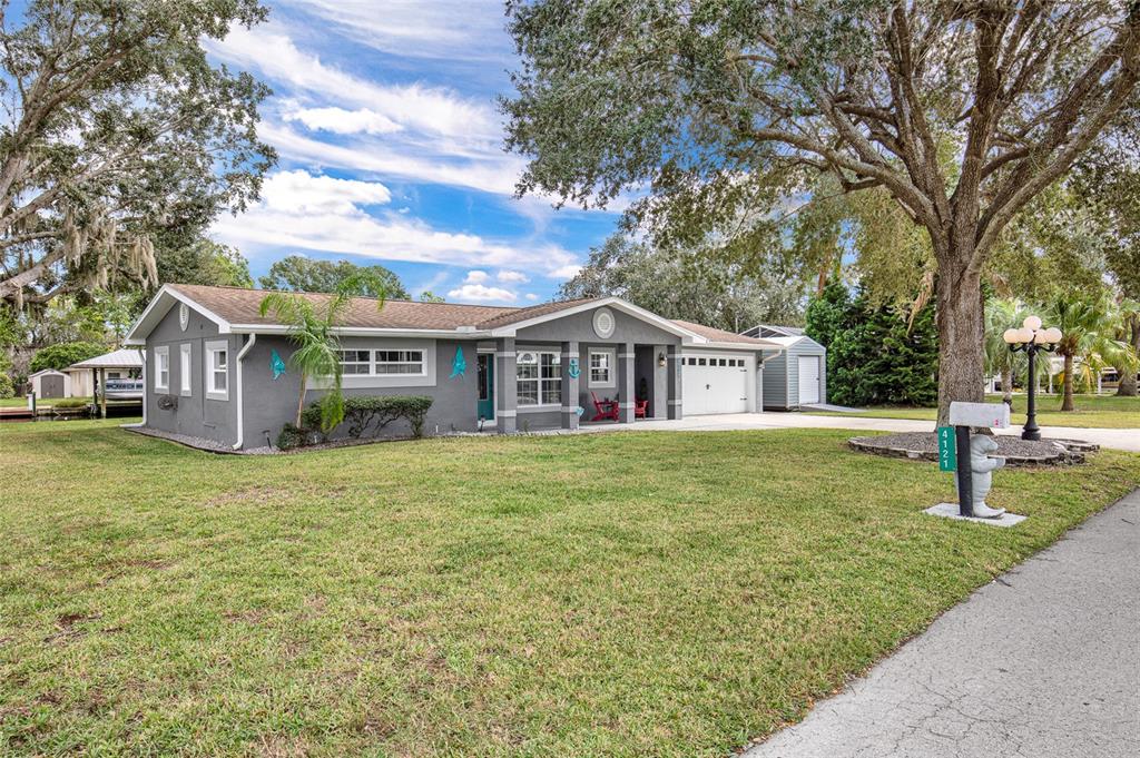 4121 South Roosevelt Point Homosassa, FL 34448 - Photo 42 of 47 a view of a house with a yard
