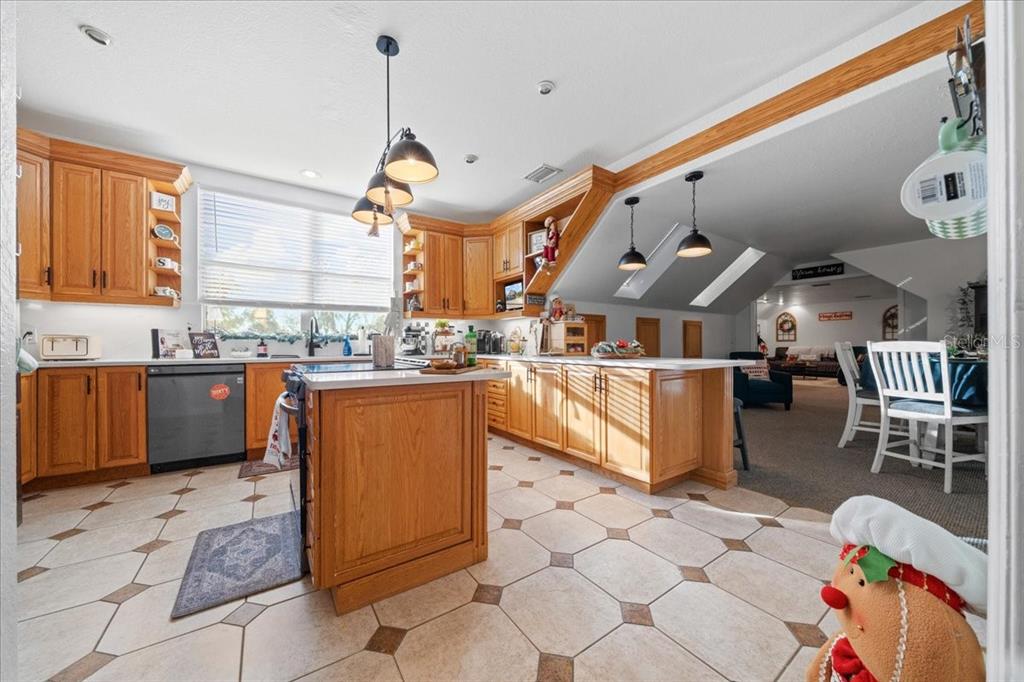 434 Southwest 14th Street, Unit A Ocala, FL 34471 - Photo 66 of 97 a kitchen with stainless steel appliances kitchen island granite countertop a table chairs in it and a window