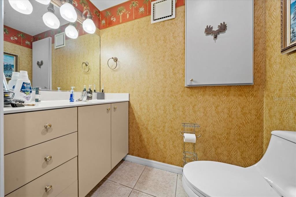 434 Southwest 14th Street, Unit A Ocala, FL 34471 - Photo 75 of 97 a bathroom with a sink mirror and toilet