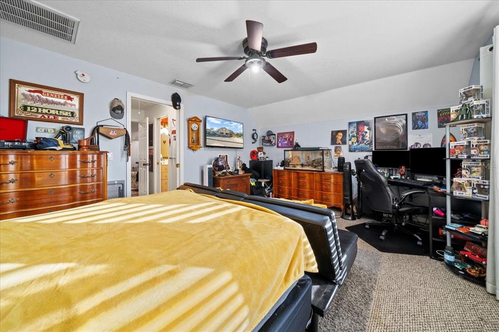 434 Southwest 14th Street, Unit A Ocala, FL 34471 - Photo 77 of 97 a bed room with a bed and a flat screen tv