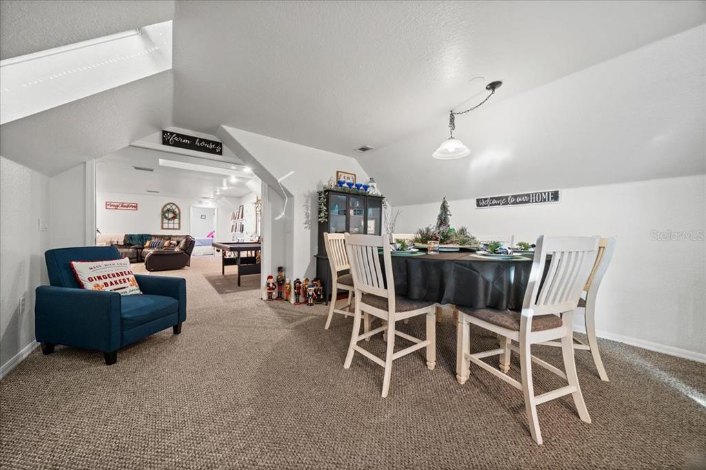 434 Southwest 14th Street, Unit A Ocala, FL 34471 - Photo 89 of 97 a living room with furniture a chandelier and a flat screen tv