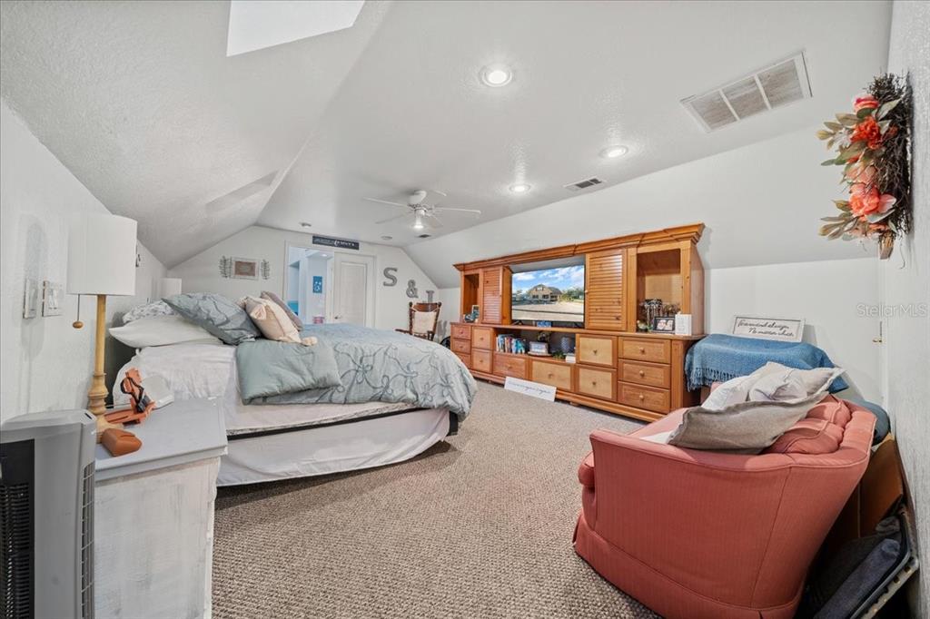 434 Southwest 14th Street, Unit A Ocala, FL 34471 - Photo 90 of 97 a living room with furniture and a flat screen tv