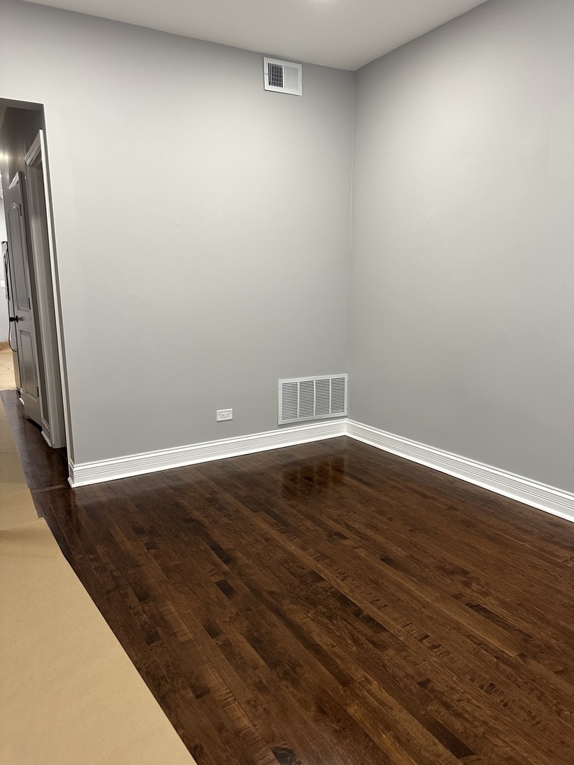 3145 West 42nd Street Chicago, IL 60632 - Photo 15 of 32 a view of an empty room with wooden floor and a window