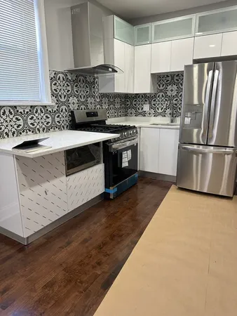 a kitchen with a refrigerator sink and cabinets