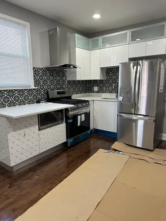a kitchen with wooden cabinets and stainless steel appliances