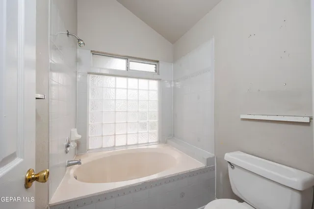 a bathroom with a toilet and bathtub