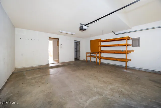 a view of empty room with stairs and a ceiling fan